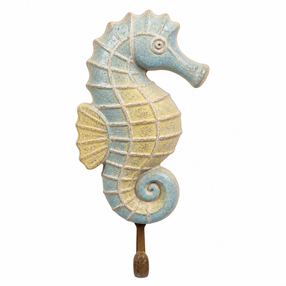 A decorative seahorse wall hook featuring a textured light blue and yellow glazed finish with a rustic brown metal hook at the bottom, shown against a plain white background.