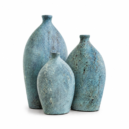 Three decorative ceramic vases in a distressed turquoise blue finish, arranged in a cluster on a white background.